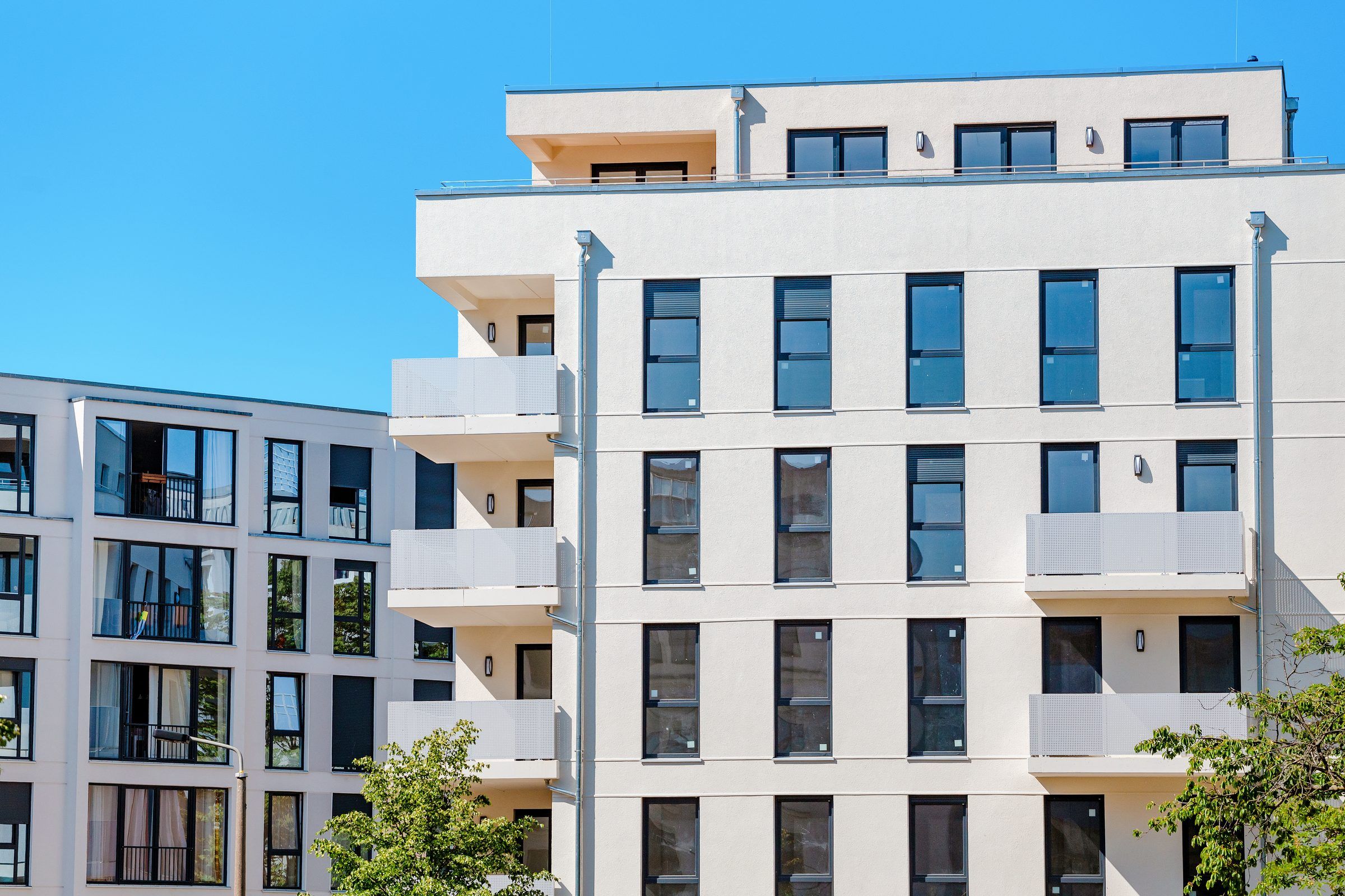 A white multi-story building with rows of windows
